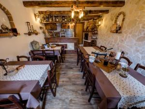 a restaurant with tables and chairs in a room at Apartments Scerbe Gordana & Miljenko Rab - Studio Apartment with Terrace 4 in Otok Rab
