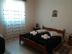 a bedroom with a bed with two pillows on it at Detached Vacation House with sea views at Chalikounas in Halikounas +31 photos