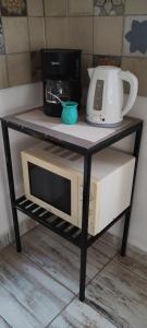 a table with a microwave and a coffee maker on it at Casa cronopio in Ushuaia