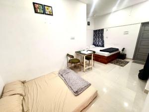 a living room with a couch and a bed and a table at Vibes stay in 5 in Hyderabad