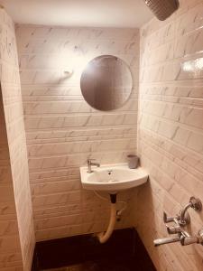 a bathroom with a sink and a mirror at Vibes stay in 5 in Hyderabad
