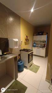 a kitchen with a stove and a counter top at Casa SUPER COP in Ananindeua +12 photos