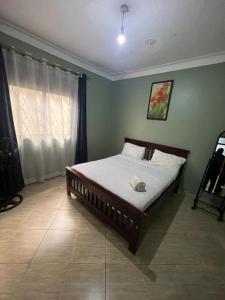 a bedroom with a bed in a room at Cozy suites 3 in Kampala