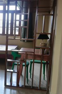 a room with a desk and a table and chairs at WanKai Homestay in Shillong