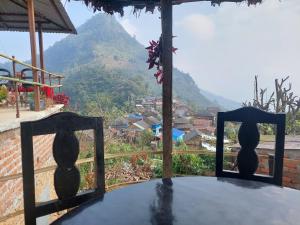 a room with a table with a view of a mountain at Culture home homestay in Bandīpur