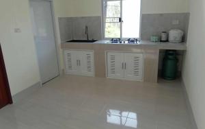 an empty kitchen with a sink and a window at Tranquility House in Ko Lanta
