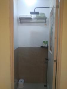 een badkamer met een toilet en een licht erboven bij SJ Vistacation in Tanza +9 foto's