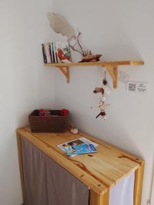 a wooden desk with a shelf on the wall at Studio in Capesterre-de-Marie-Galante