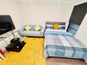 a bedroom with a bed and a couch at Modern King Suite on Swan Valley Doorstep in West Swan