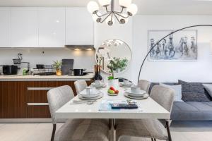 a dining room with a white table and chairs at Dominiks silent and quite Classic 1 Bedroom 47 sqm Tambuli Pool Balcony Beach Mactan up to 6 People in Lapu Lapu City