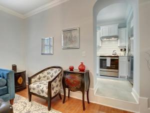 a living room with a chair and a table at Liberty Street Retreat in Savannah