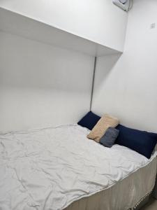 a bed with two pillows on it in a room at The Roam Inn - Fast Wifi Connection in Dipolog