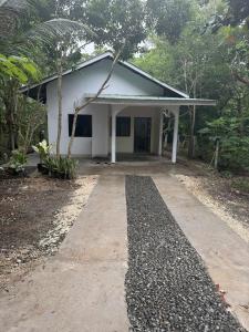 a white building with a driveway in front of it at Casa Fleur in Cangalwang