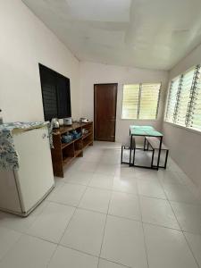 a kitchen with a refrigerator and a table in it at Casa Fleur in Cangalwang