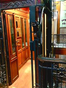 a hallway with wooden doors in a building at Ivy hotel in Alexandria