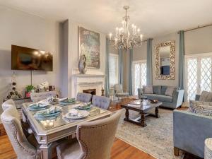 a living room with a dining table and a fireplace at Southern Hall Lower in Savannah