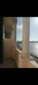 a view of the ocean from a building with columns at Ivy hotel in Alexandria