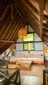 a living room with two couches and a large window at Lakeside retreat and Golf in Bedugul in Bedugul