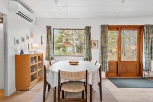 a dining room with a table and chairs and a window at FY358-Martofte-Sandvejen-3 in Martofte
