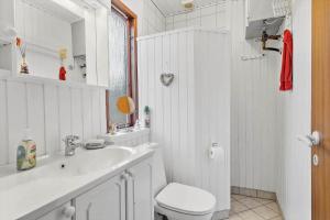 a white bathroom with a toilet and a sink at FY358-Martofte-Sandvejen-3 in Martofte +27 photos