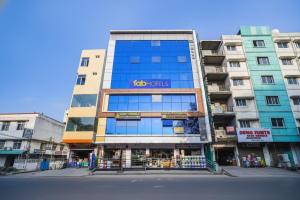 a tall building with a sign on the front of it at FabHotel Grand Broholic - Nr Hitech City in Hyderabad
