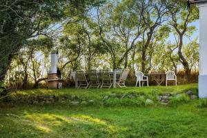 a table and chairs in a yard with trees at FY297-Faaborg-Ostergyden-37 in Faaborg