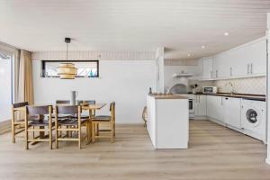 a kitchen and dining room with a table and chairs at FY290-Faaborg-Egholmvej-14 in Faaborg