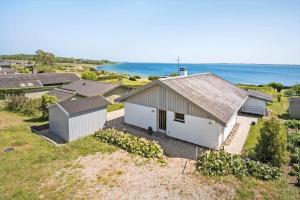 an aerial view of a house with the ocean in the background at FY290-Faaborg-Egholmvej-14 in Faaborg +13 photos