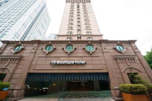 a building with a clock tower on top of it at Doksan 3S Hotel in Seoul