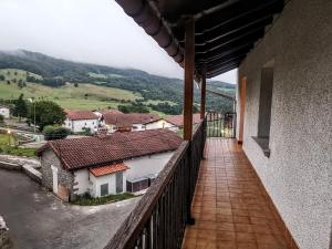 a balcony of a house with a view of a mountain at GURE TXOKO Casa Rural in Odériz