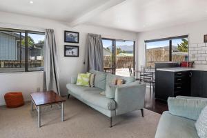 a living room with a couch and a table at Sparkling 3-bedroom home with fireplace and views in National Park
