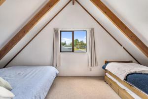 a attic bedroom with two beds and a window at Sparkling 3-bedroom home with fireplace and views in National Park