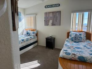 a bedroom with two beds and a sign that reads beach house at Blue River Oasis in Bullhead City