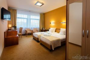 Postel nebo postele na pokoji v ubytování Hotel Victor Pruszków DeSilva