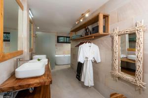 a bathroom with a white sink and a tub at Samaraya Wellness Resort in Amphoe Koh Samui +27 photos