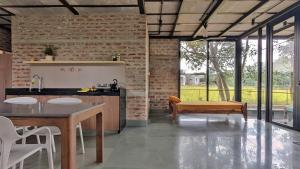 a kitchen with a table and a bench in a room at ZERO9 farmPAD - Private Eco Retreat, Karjat in Karjat