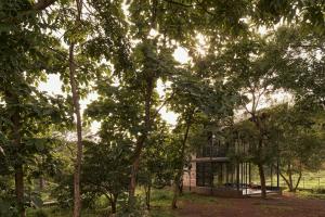 a building in the middle of some trees at ZERO9 farmPAD - Private Eco Retreat, Karjat in Karjat
