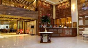 a lobby of a hotel with a vase of flowers on a table at Au Lac 2 Hotel in Ho Chi Minh City