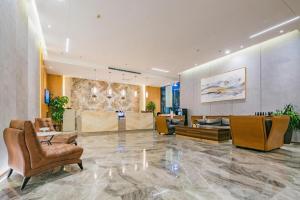 a lobby with couches and chairs in a building at Xian Katie Eastman Hotel in Xi'an