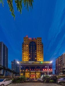 a tall building with lights on top of it at Fuzhou Fuqing Ruixin Hotel in Rongcheng