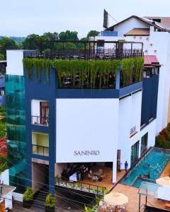 an apartment building with a swimming pool at Saninro Hotel - Ragama in Ragama