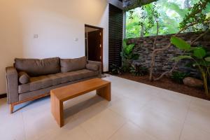 a living room with a couch and a coffee table at Sandila Villa in Matara