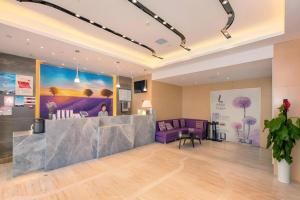 a lobby with a reception desk and purple furniture at Lavande Hotel Wuhan Jianghan Road Subway Station in Wuhan