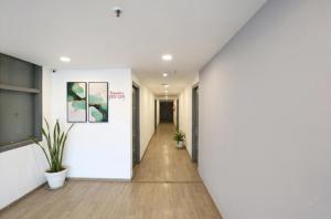 a hallway with white walls and a white wall at Via Blusky in New Delhi