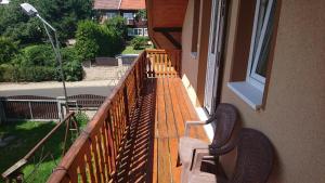 a wooden bench sitting on the porch of a house at Penzion U Zvonku in Litvínov