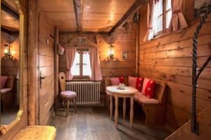 a small room with a table and chairs in a cabin at Hotel Romantica in Zermatt +37 photos