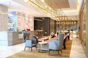 a lobby of a restaurant with chairs and tables at Magnotel Nanjing Lishui Baota Bei Road in Lishui