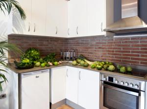 a kitchen with a bunch of vegetables on the counter at Centric Gracia Apartments in Barcelona