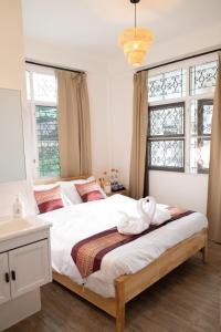 a bedroom with a large bed with towels on it at Bangkok Neighborhouse - Guesthouse in Bangkok