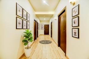 a hallway with a potted plant in a room at FabHotel Solitaire Inn in Kānpur